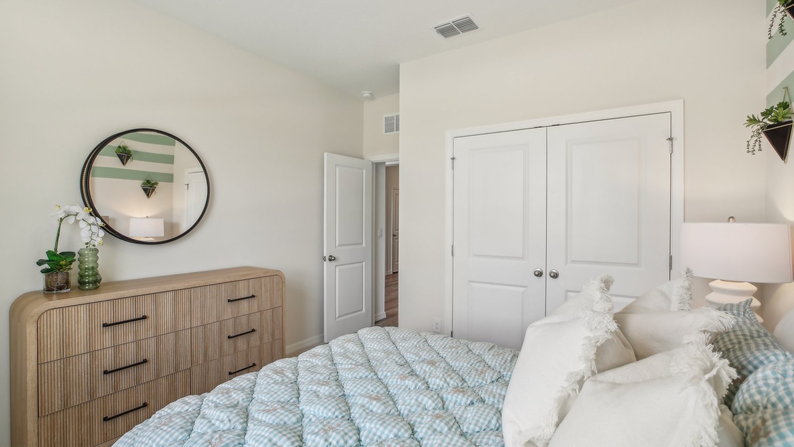 Guest bedroom with bed, nightstands and a roomy closet for storage.