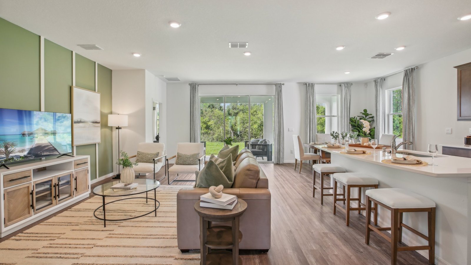 Open concept living area with couch seating and access to the backyard thru slider door.