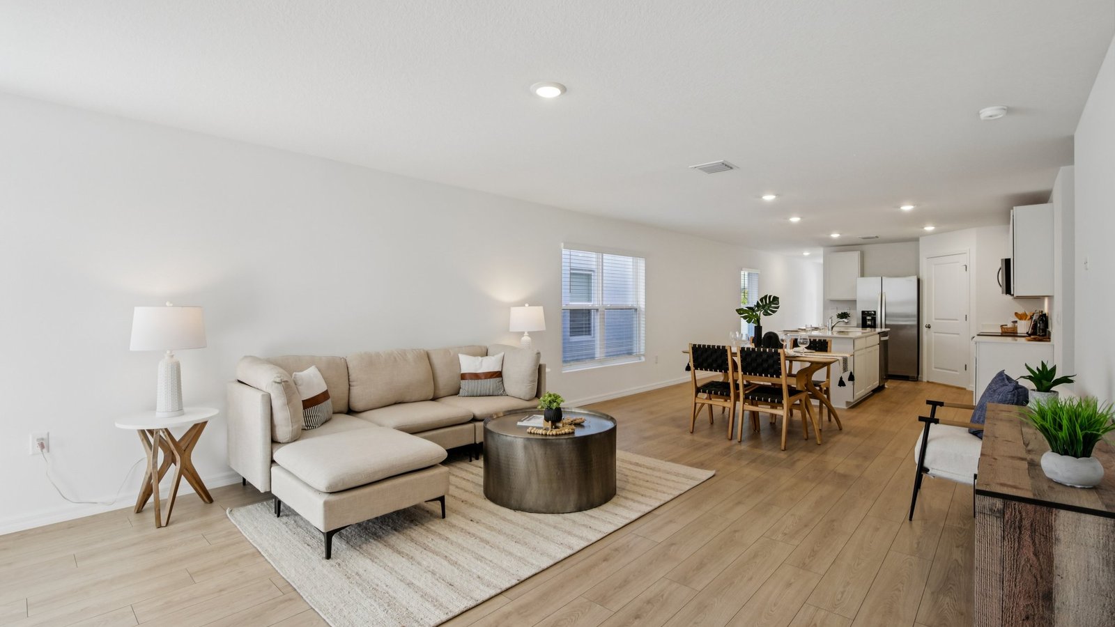 Open concept living area with couch seating and access to the backyard thru slider door.