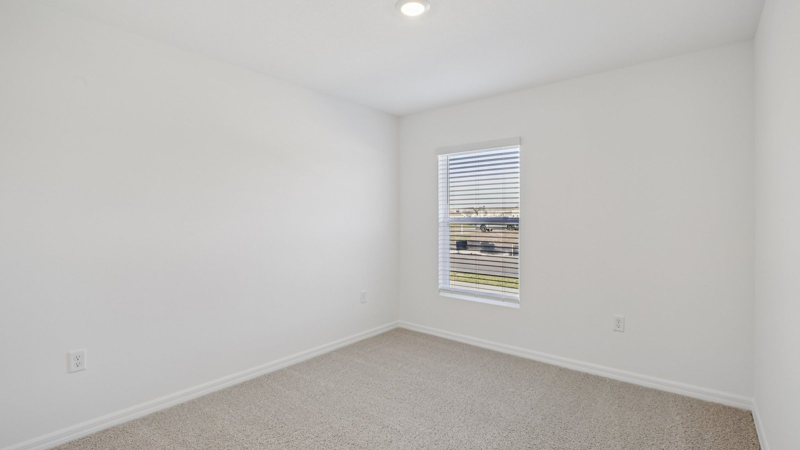 Spare bedroom for guests, with bed, dresser, and ample closet storage.