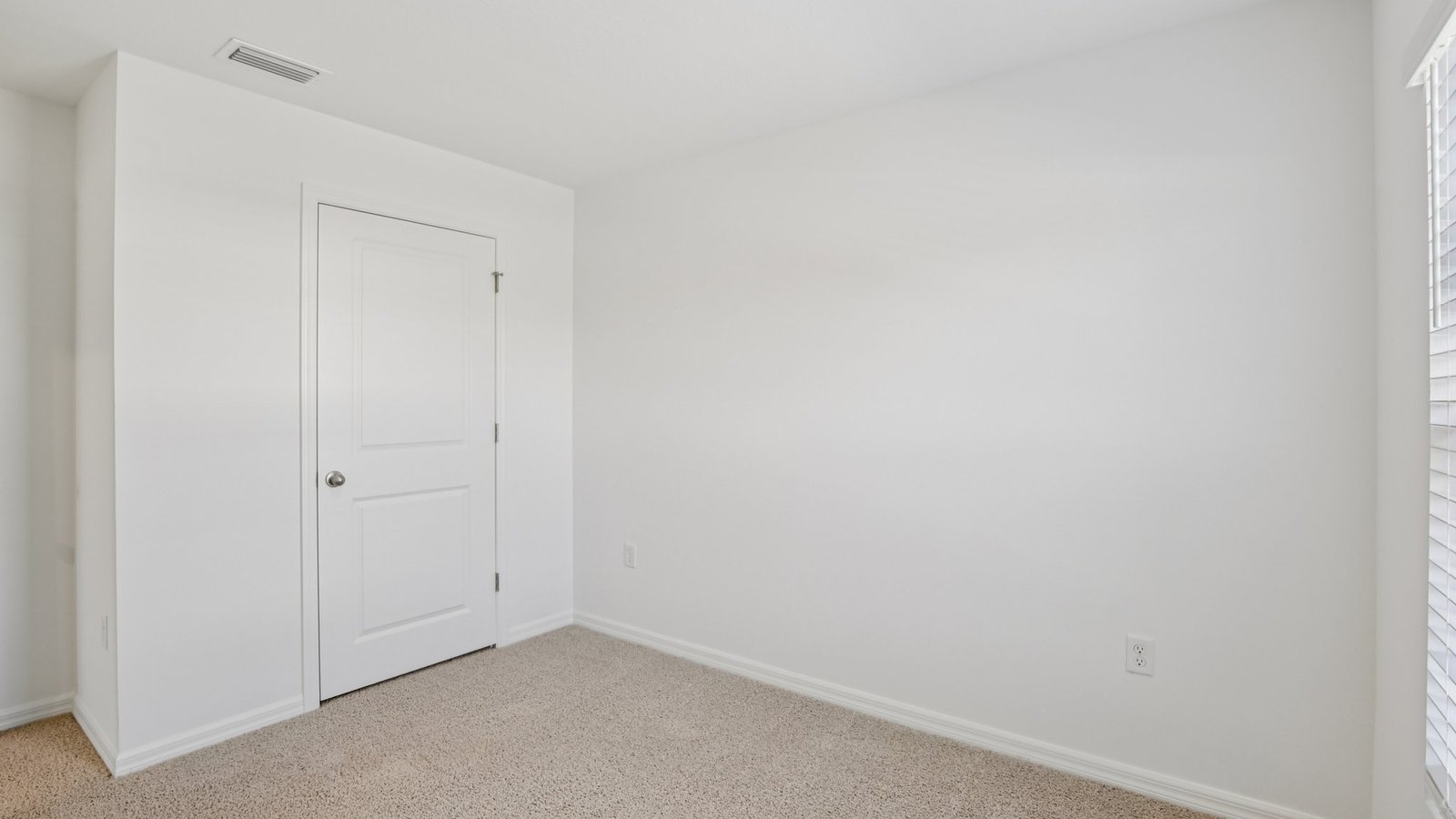 Spare bedroom for guests, with bed, dresser, and ample closet storage.