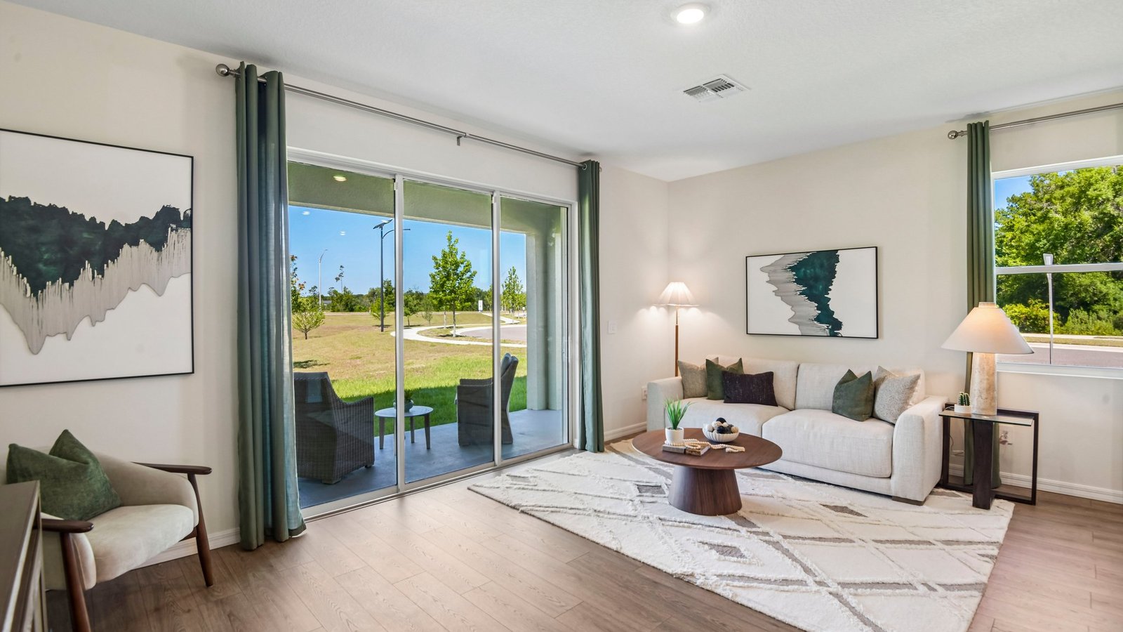 Kitchen with island seating, quartz counters, spacious pantry and stainless-steel appliances.