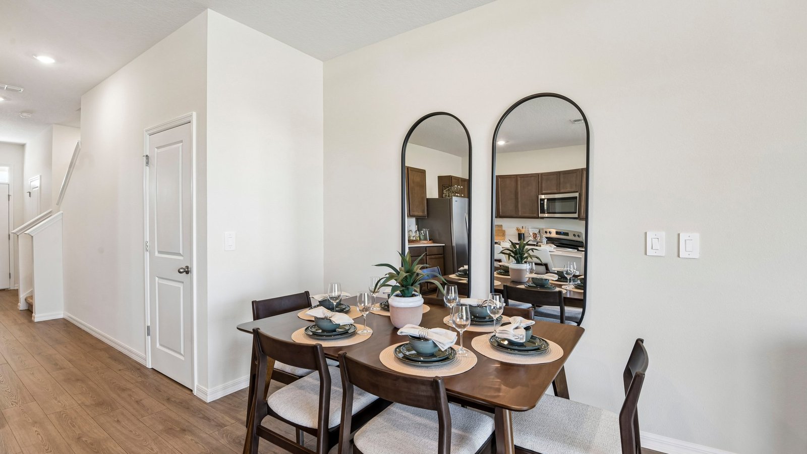 Dining room adjacent to the kitchen with table, chairs and LVP flooring.