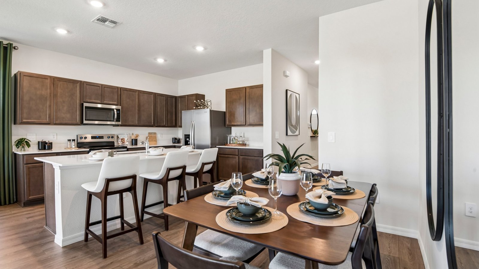 Dining room adjacent to the kitchen with table, chairs and LVP flooring.