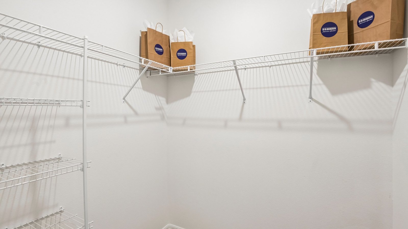 Spacious walk in closet with abundant shelving and storage.