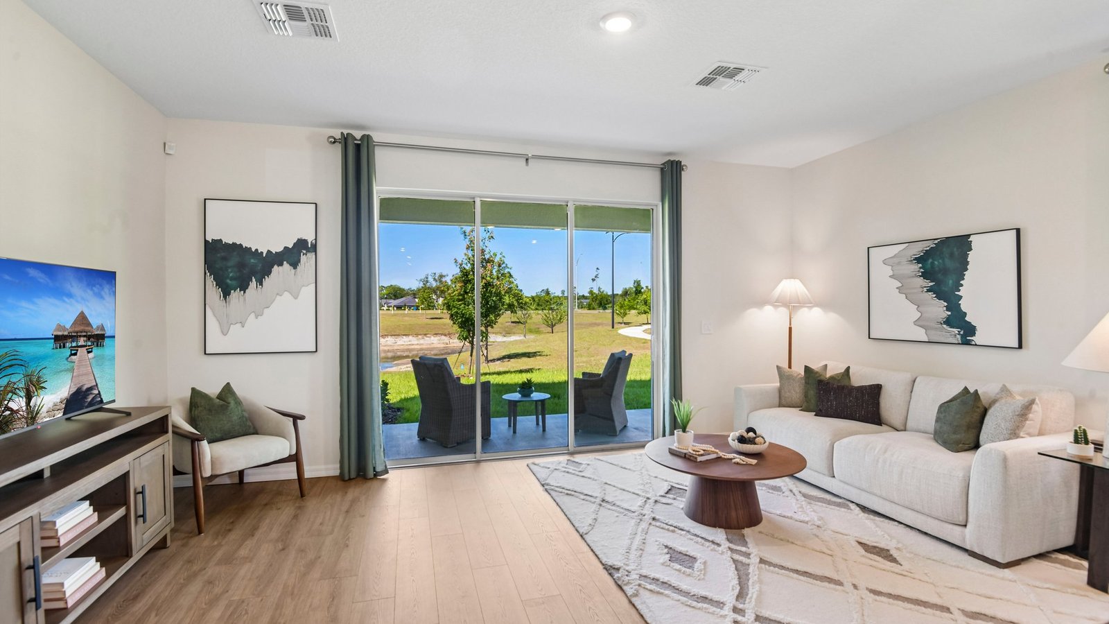 Kitchen with island seating, quartz counters, spacious pantry and stainless-steel appliances.
