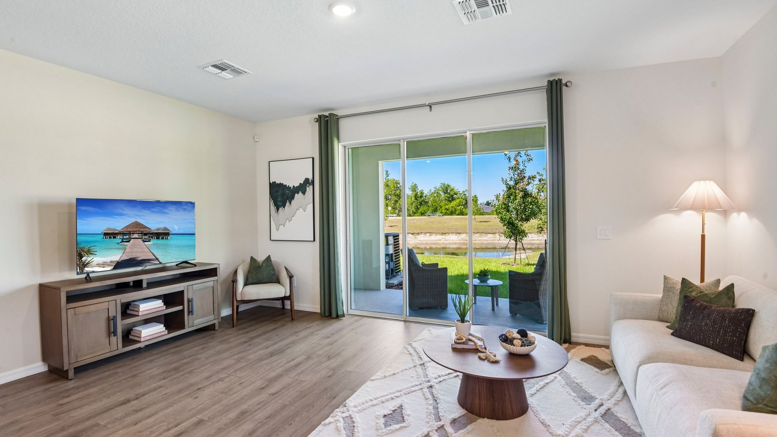 Kitchen with island seating, quartz counters, spacious pantry and stainless-steel appliances.
