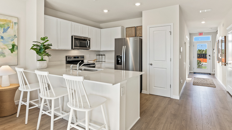Open-concept kitchen in the pearson floorplan at Reserve at River Hayes by D.R. Horton in Bradenton Florida