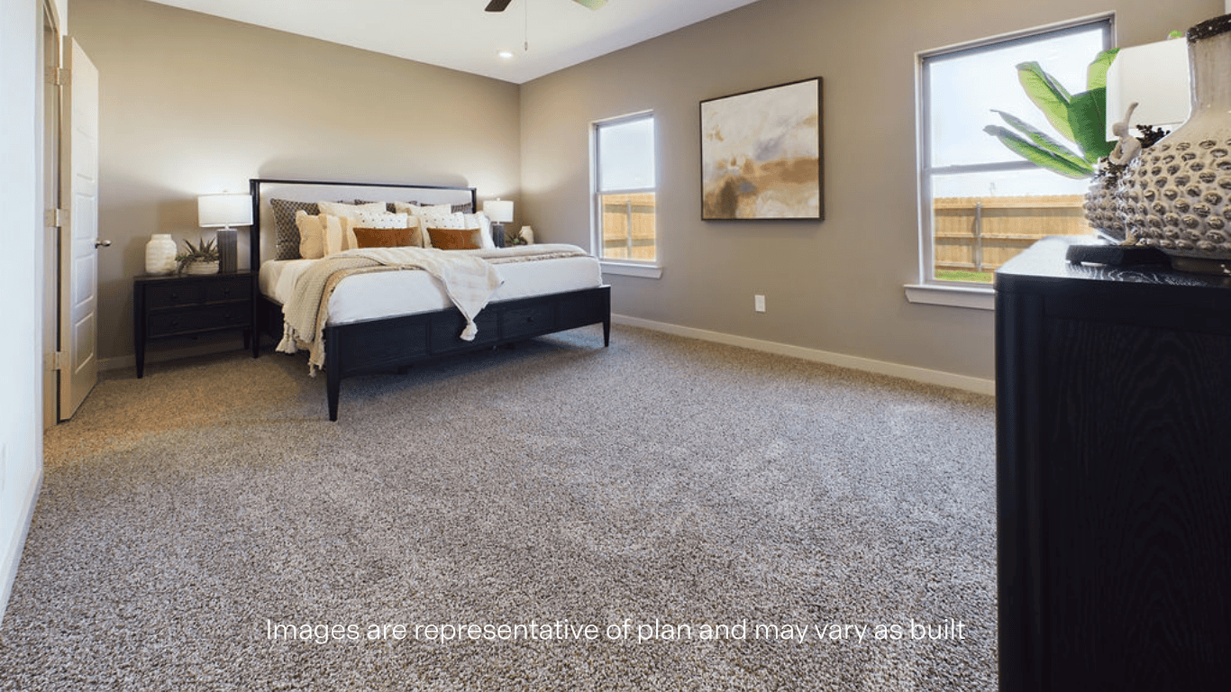 Primary bedroom with plush carpet floors and light allowing double windows