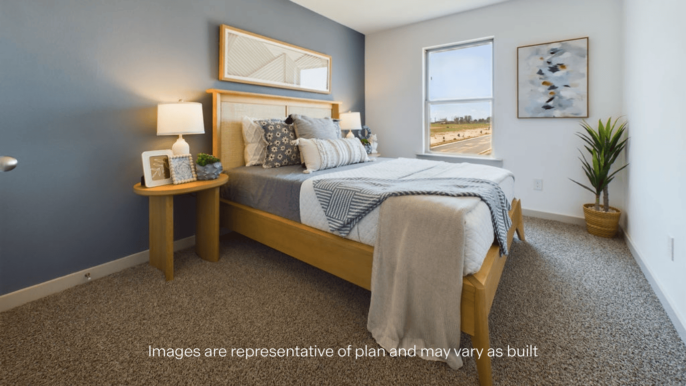 Guest bedroom with plush carpet and ample luighting