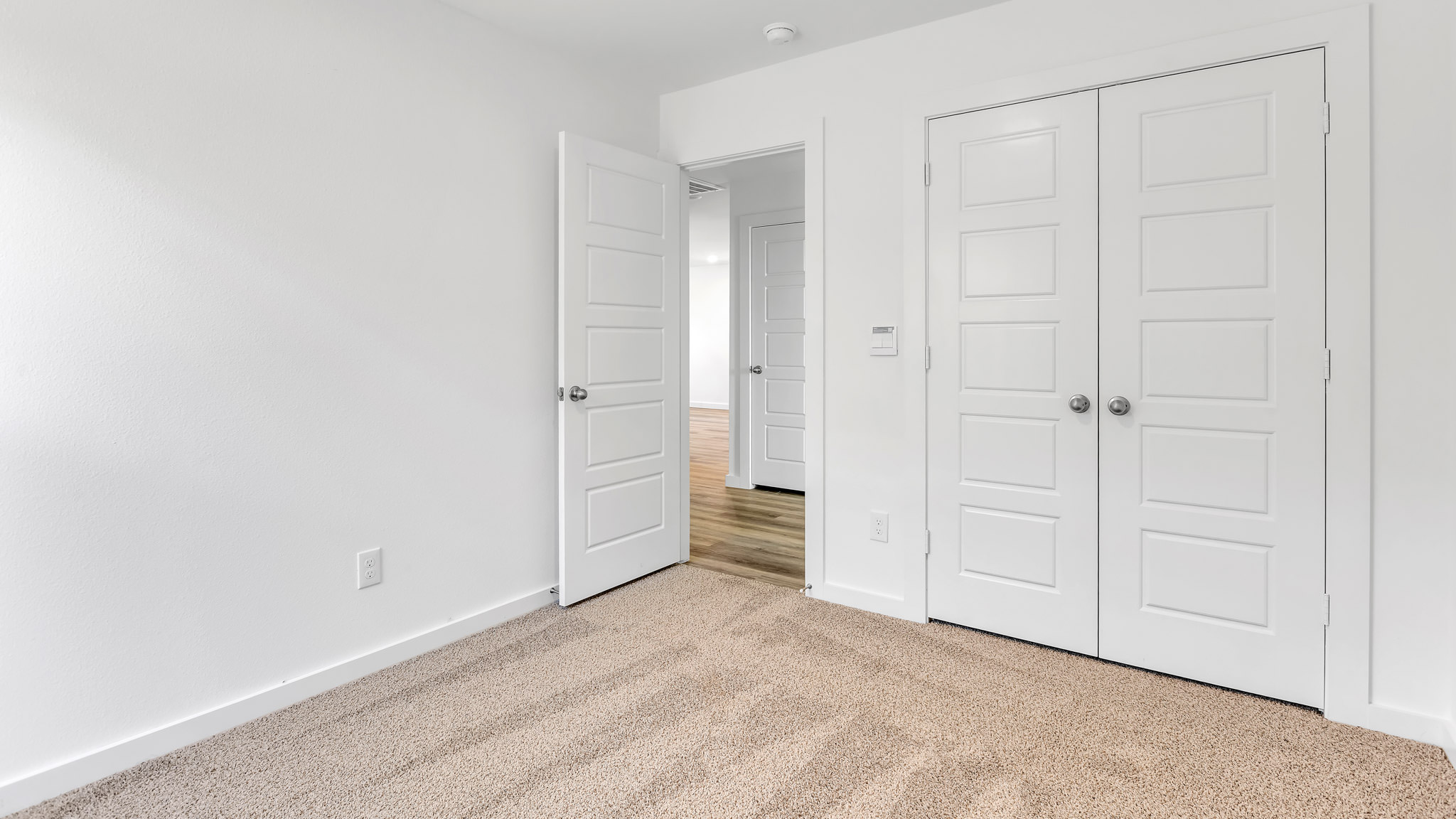 Guest bedroom 2 with plush carpet floors and spacious closet