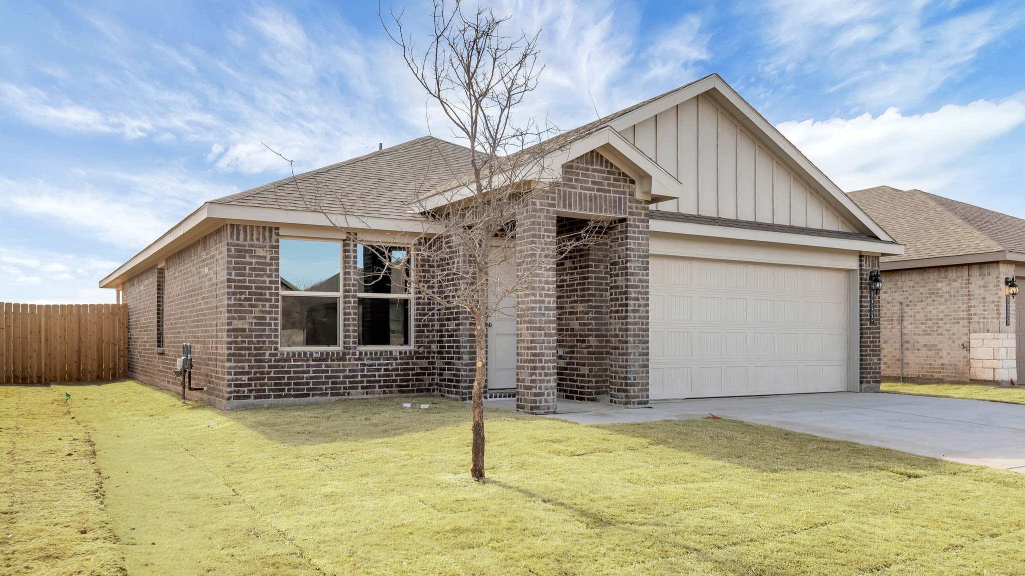 Side view of single story timeless brick home