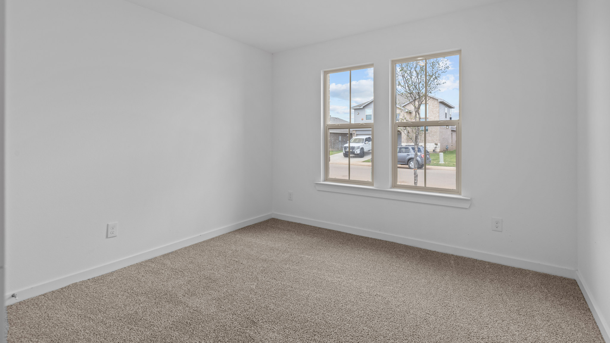 Guest bedroom 1 with front windows and ample natural light