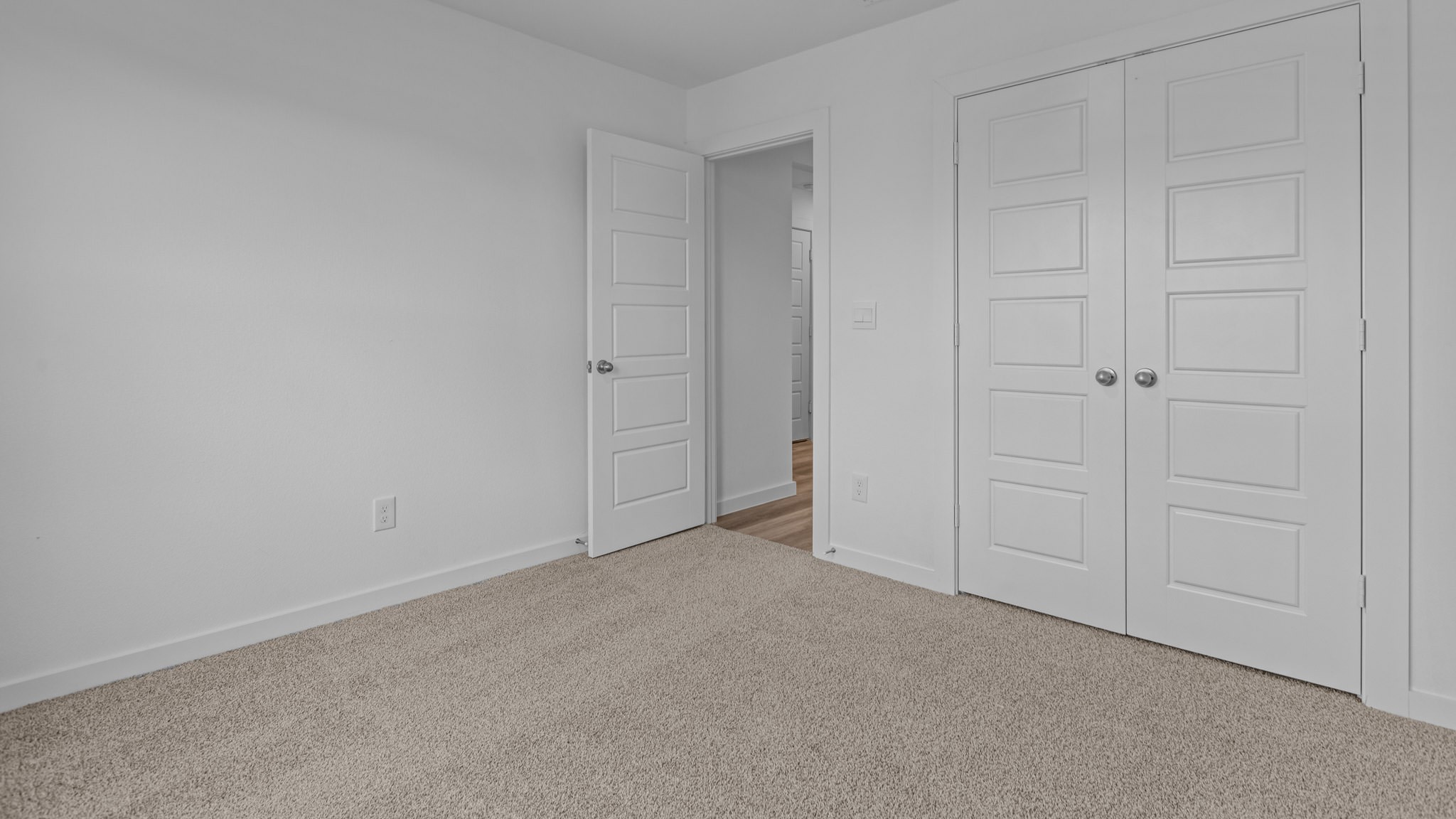 Guest bedroom 1 with front windows and ample natural light