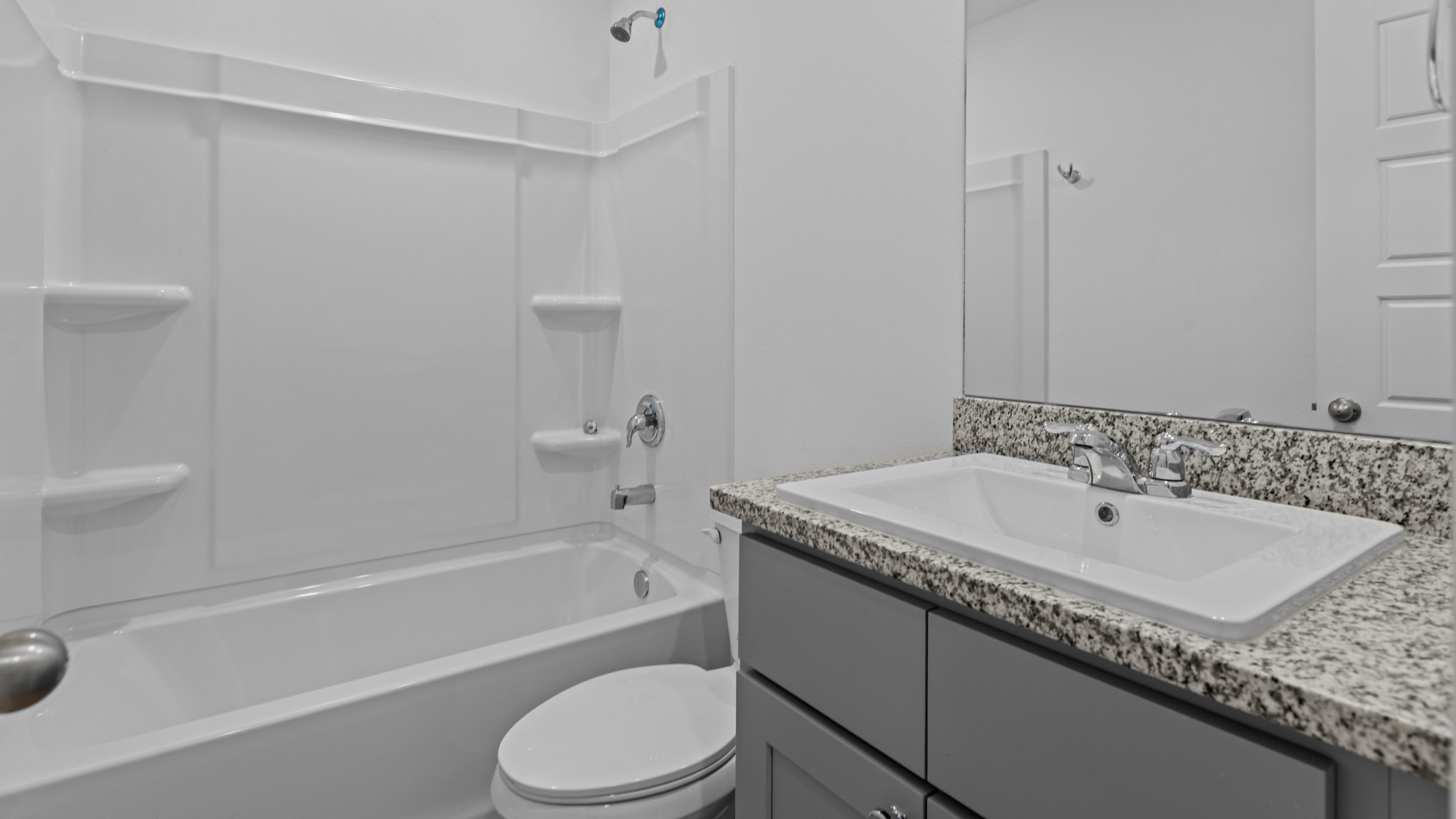 Guest bathroom with built in vanity and combination bathtub shower