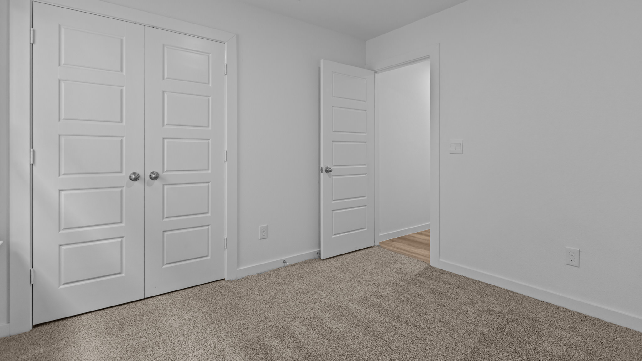 Guest bedroom 2 with side window and plush carpet floor