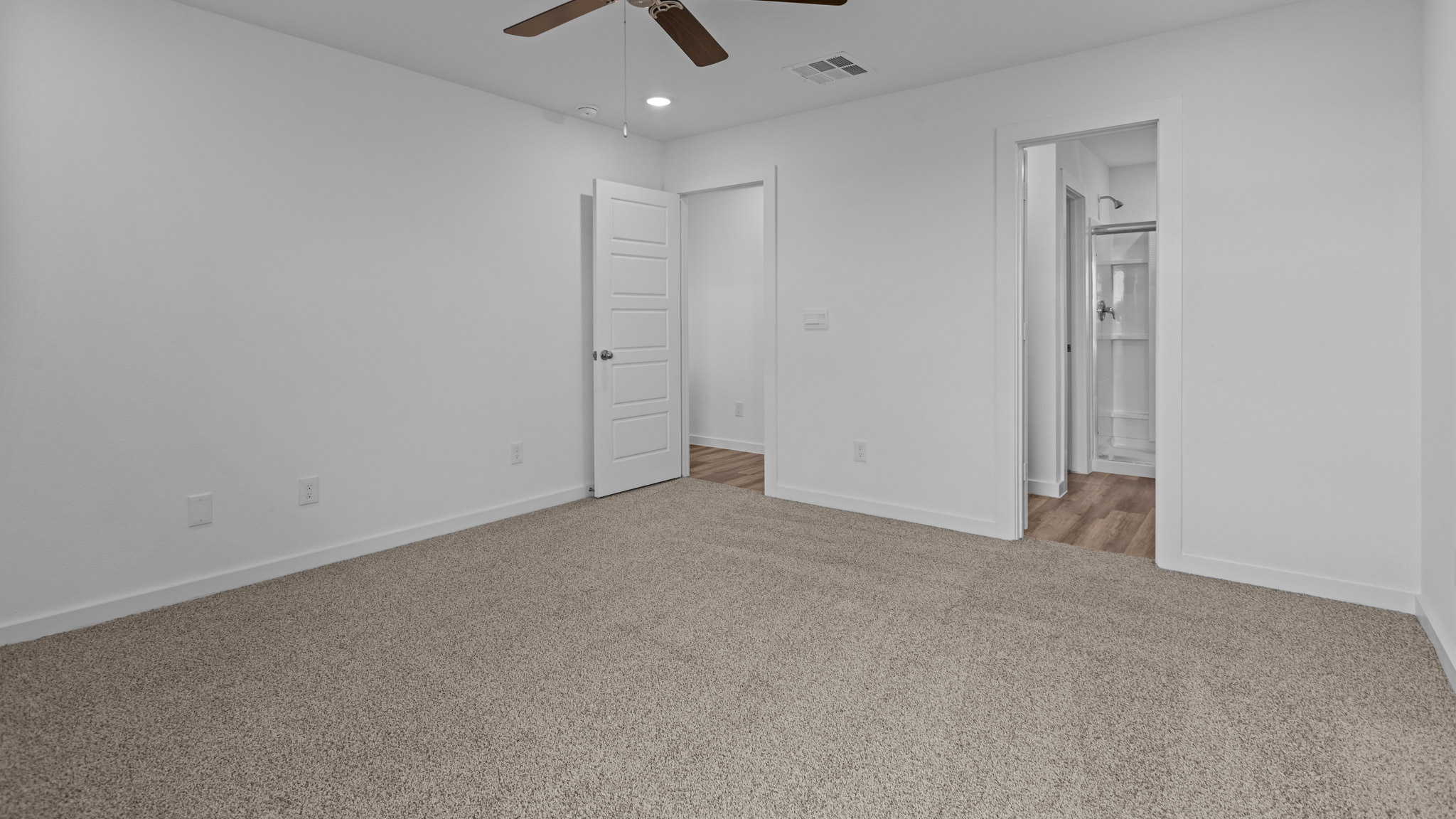 Primary bedroom with private attached bathroom and walk-in closet