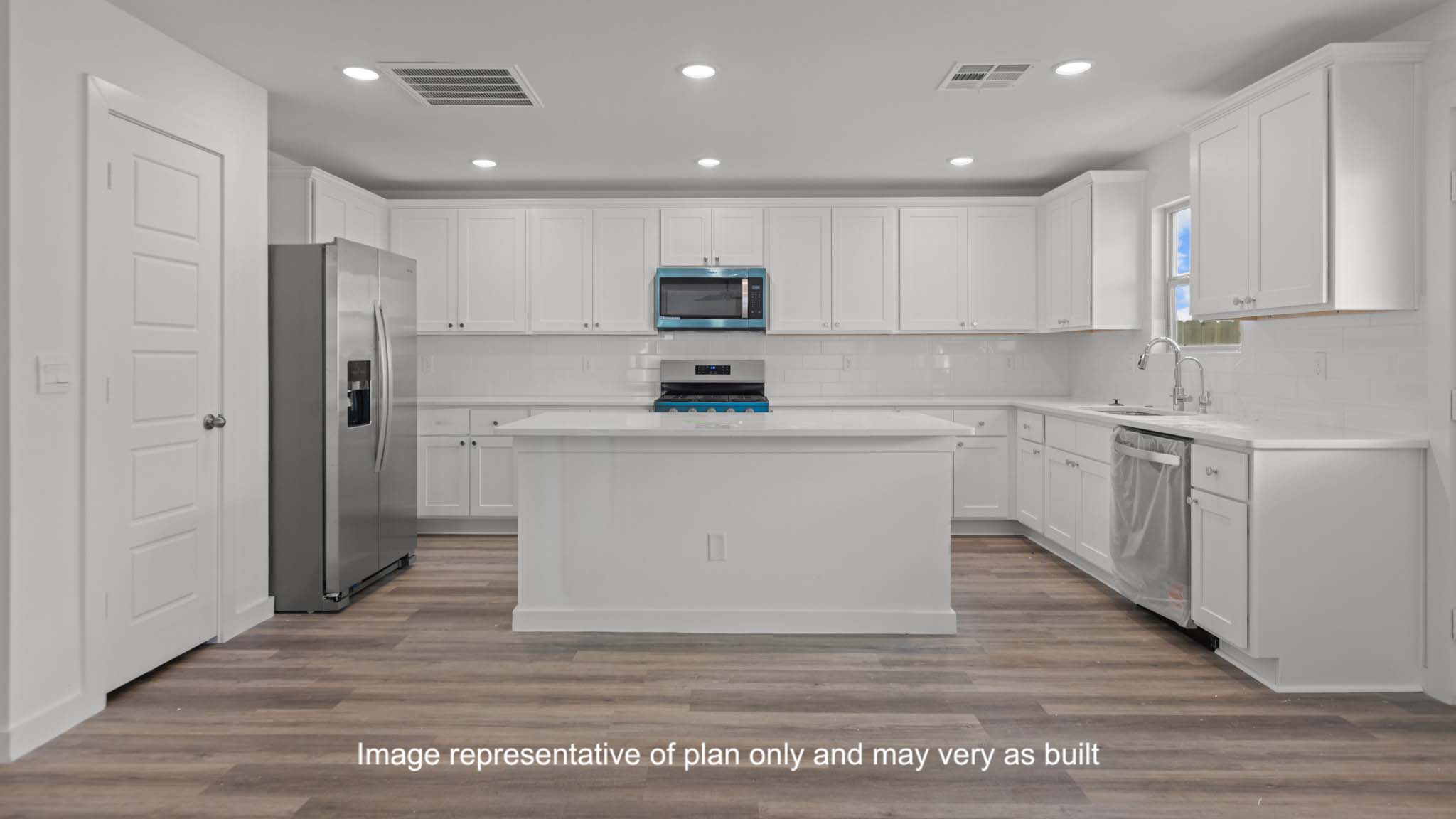 Open concept kitchen with stainless steel appliances, shaker style cabinets, and elevated finishes