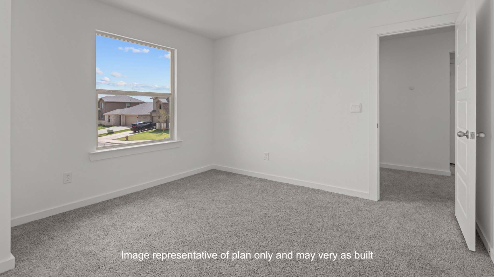 Guest bedroom 1 with plush carpet floors and spacious closet