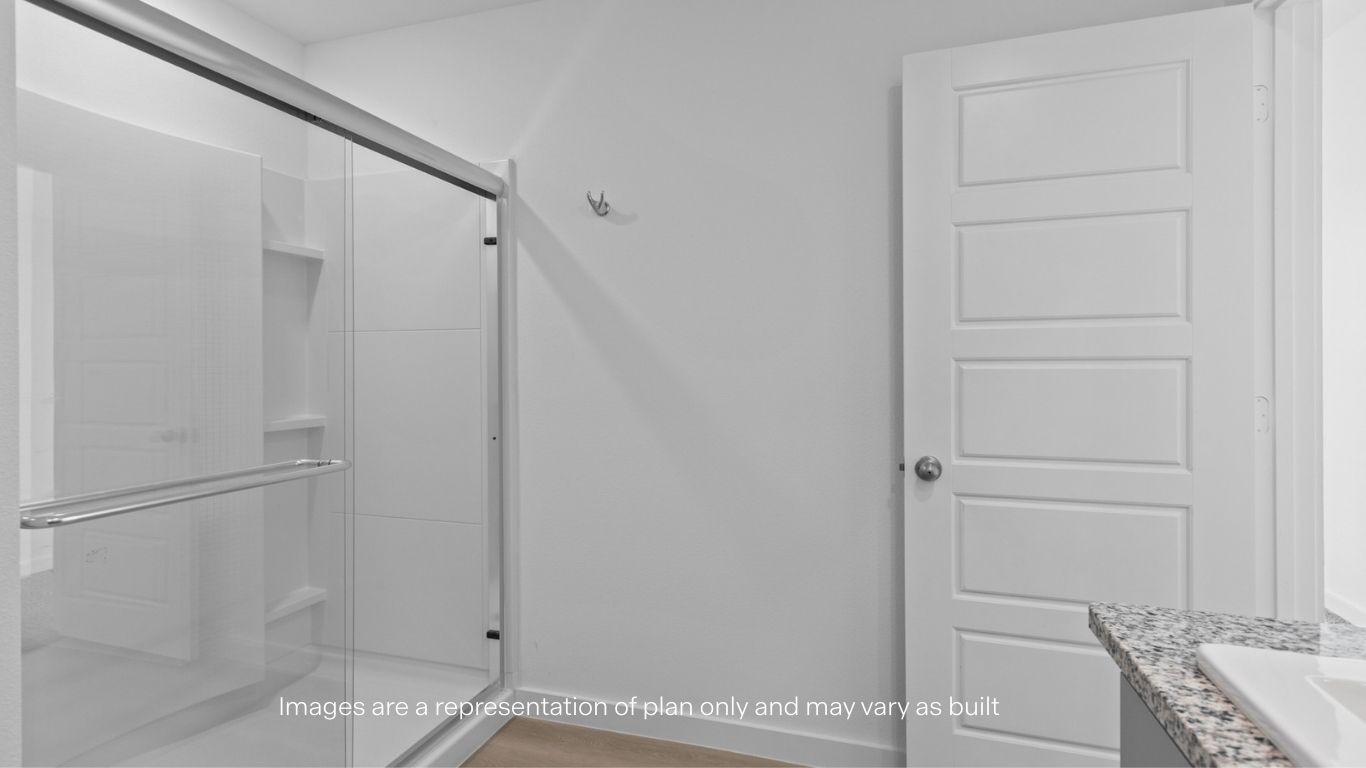 Private attached primary bathroom with built in vanity and luxurious shower