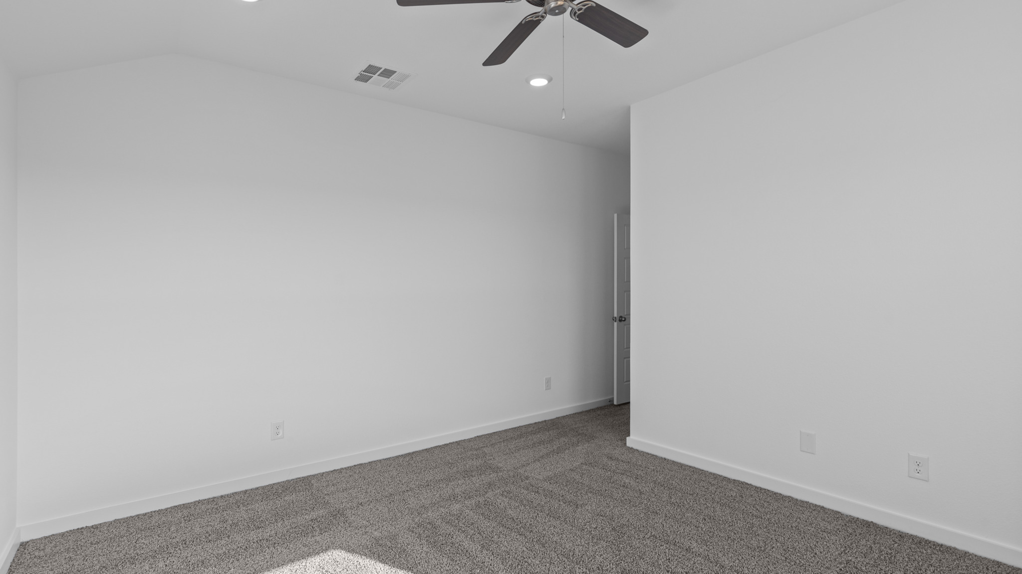 Secondary bedroom with plush carpet and white interior