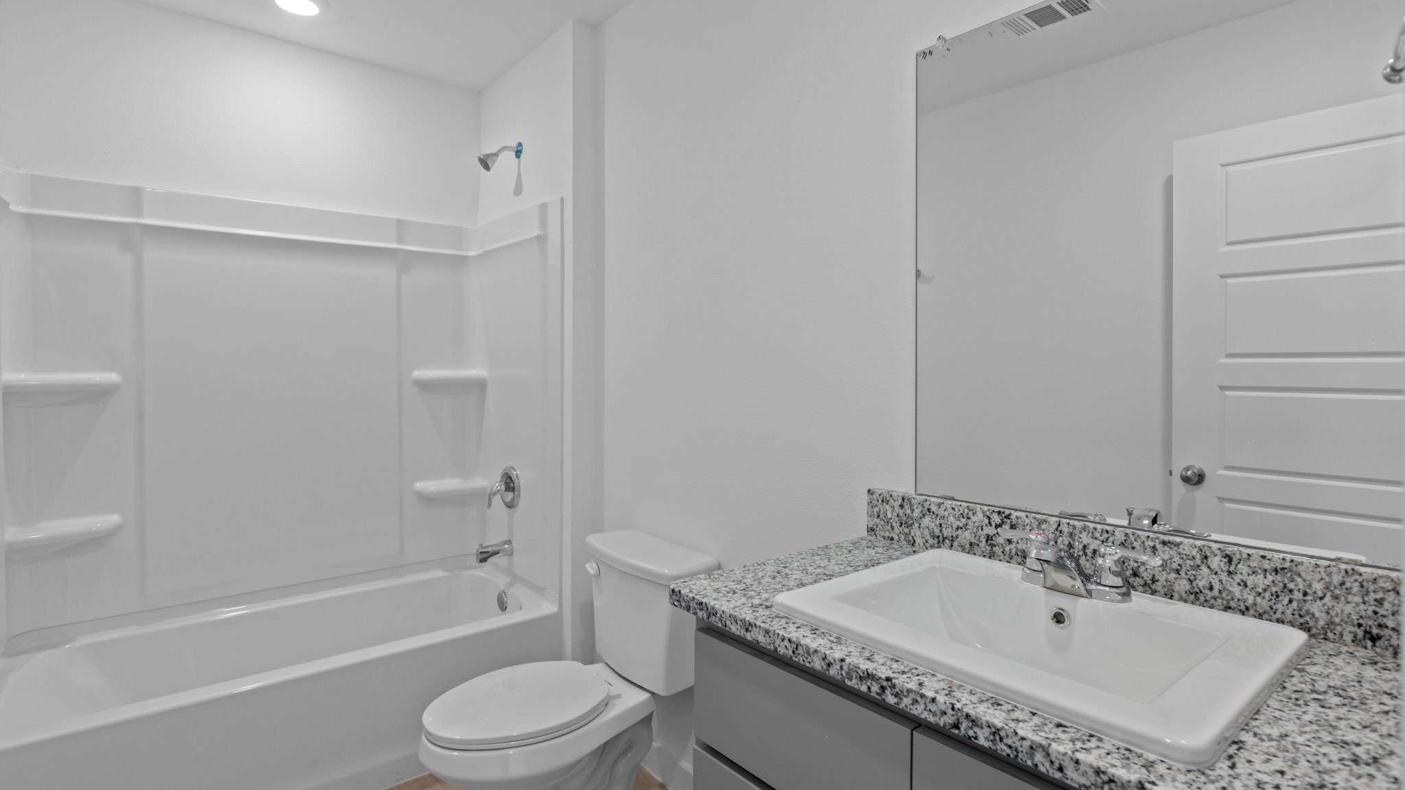 Guest bath with single sink, vanity, granite counters and bath tub shower combo
