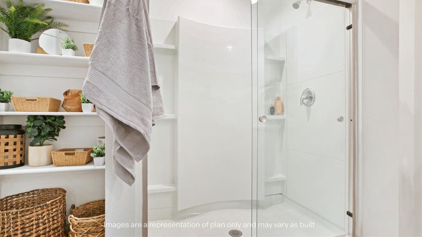Private attached primary bathroom with built in vanity and luxurious shower