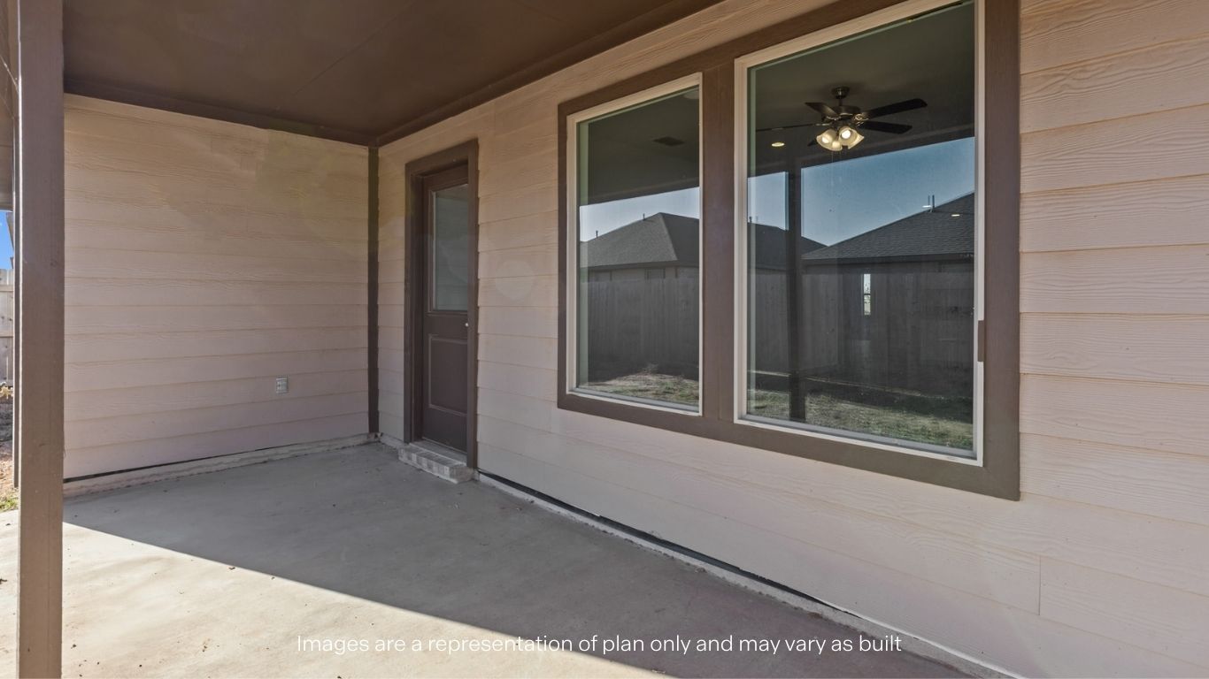 Covered back patio area overlooking spacious backyard