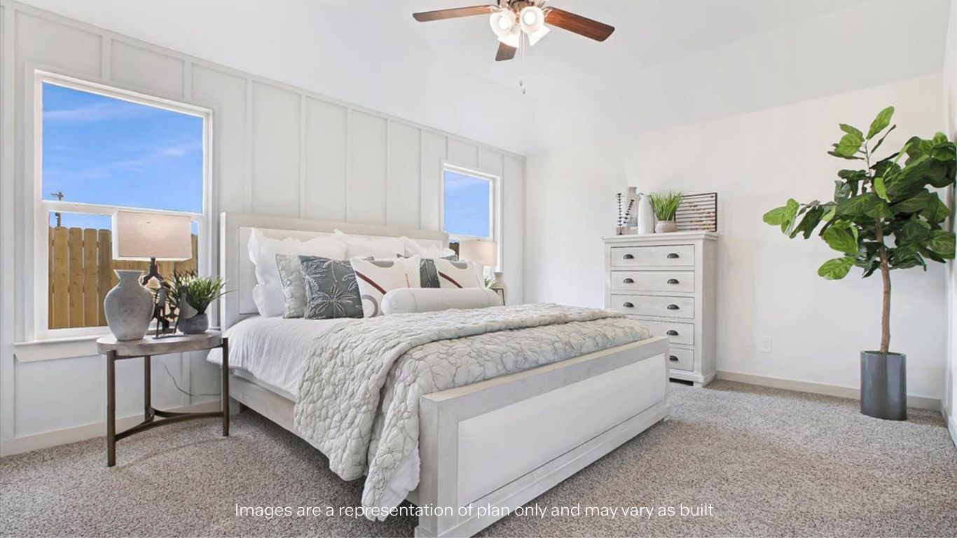 Primary bedroom with plush carpet floors and light allowing double windows