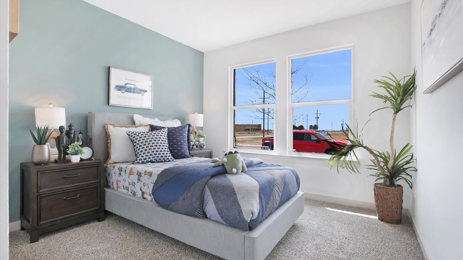 Guest bedroom with white interior, plush carpet and 2 windows