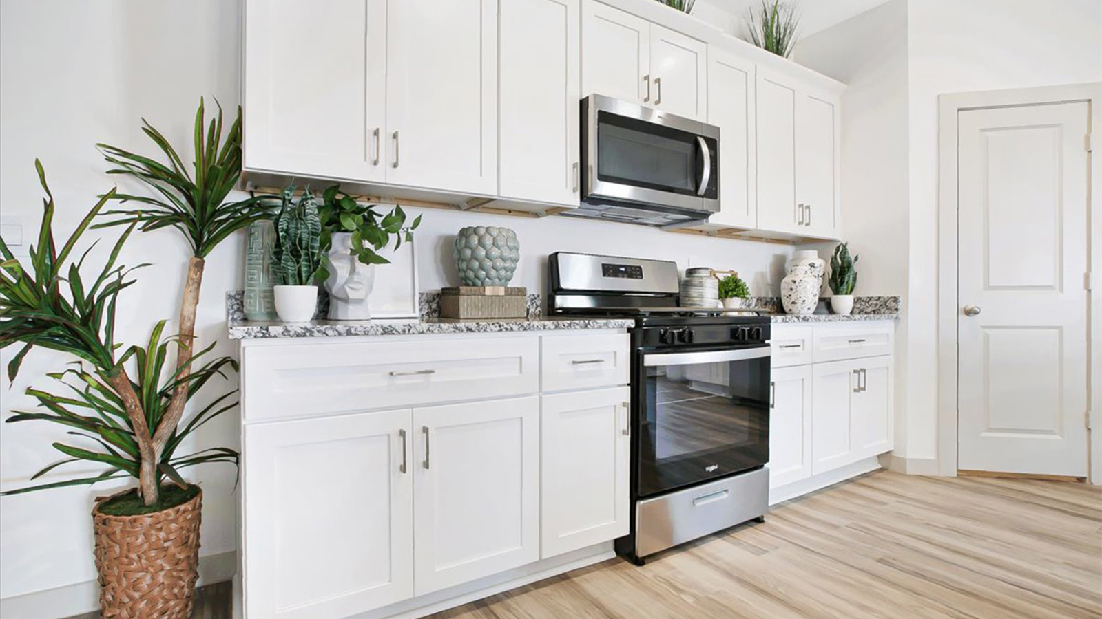 Kitchen with white cabinets and granite counter tops