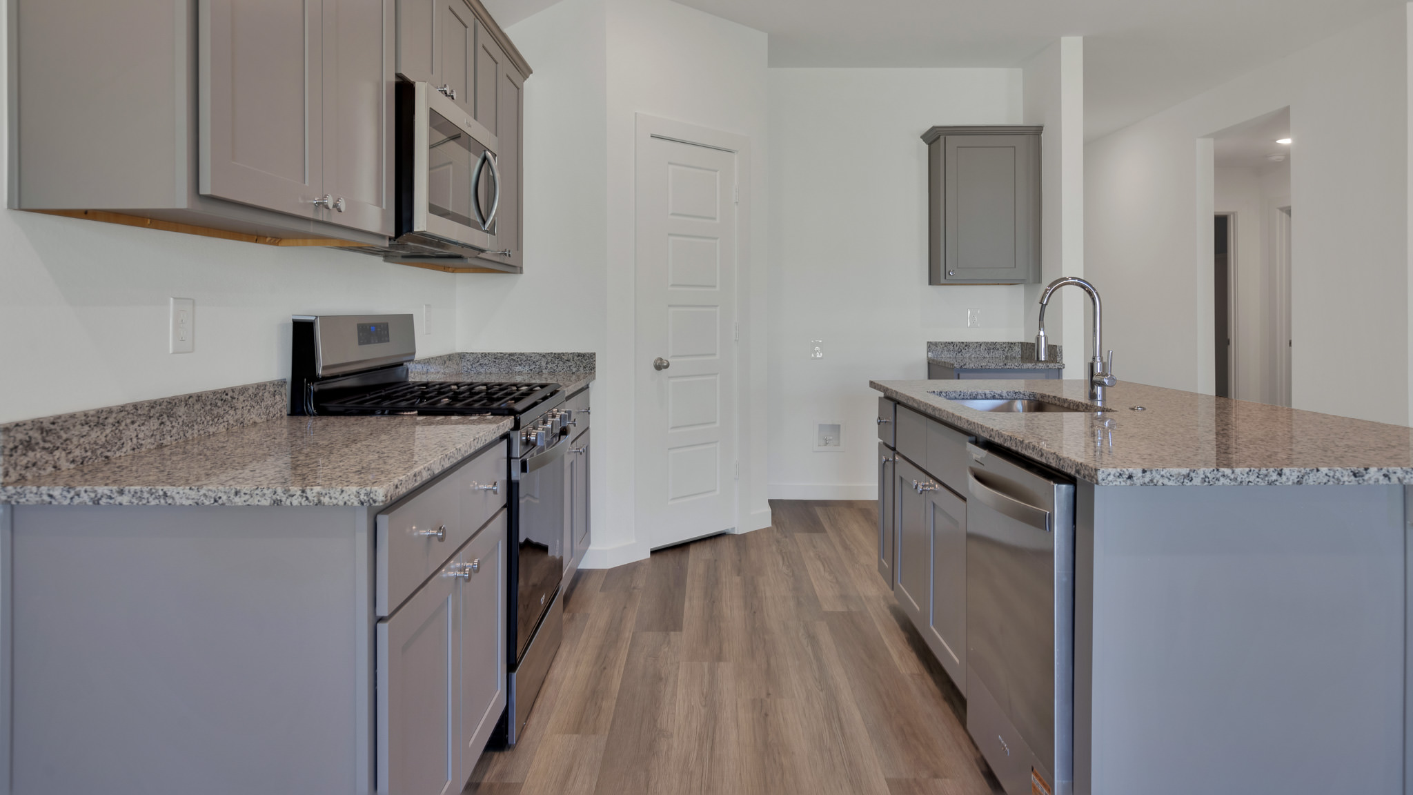 Modern kitchen with stainless steel appliances and shaker style cabinets