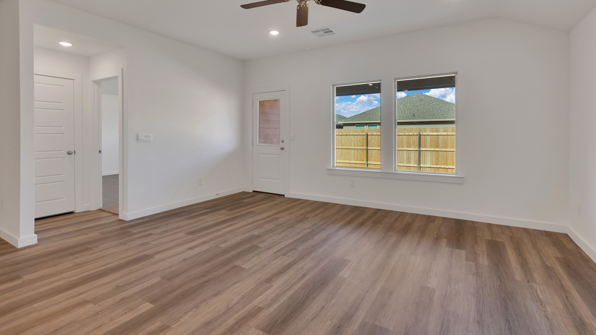 Open concept living and family room with ample lighting