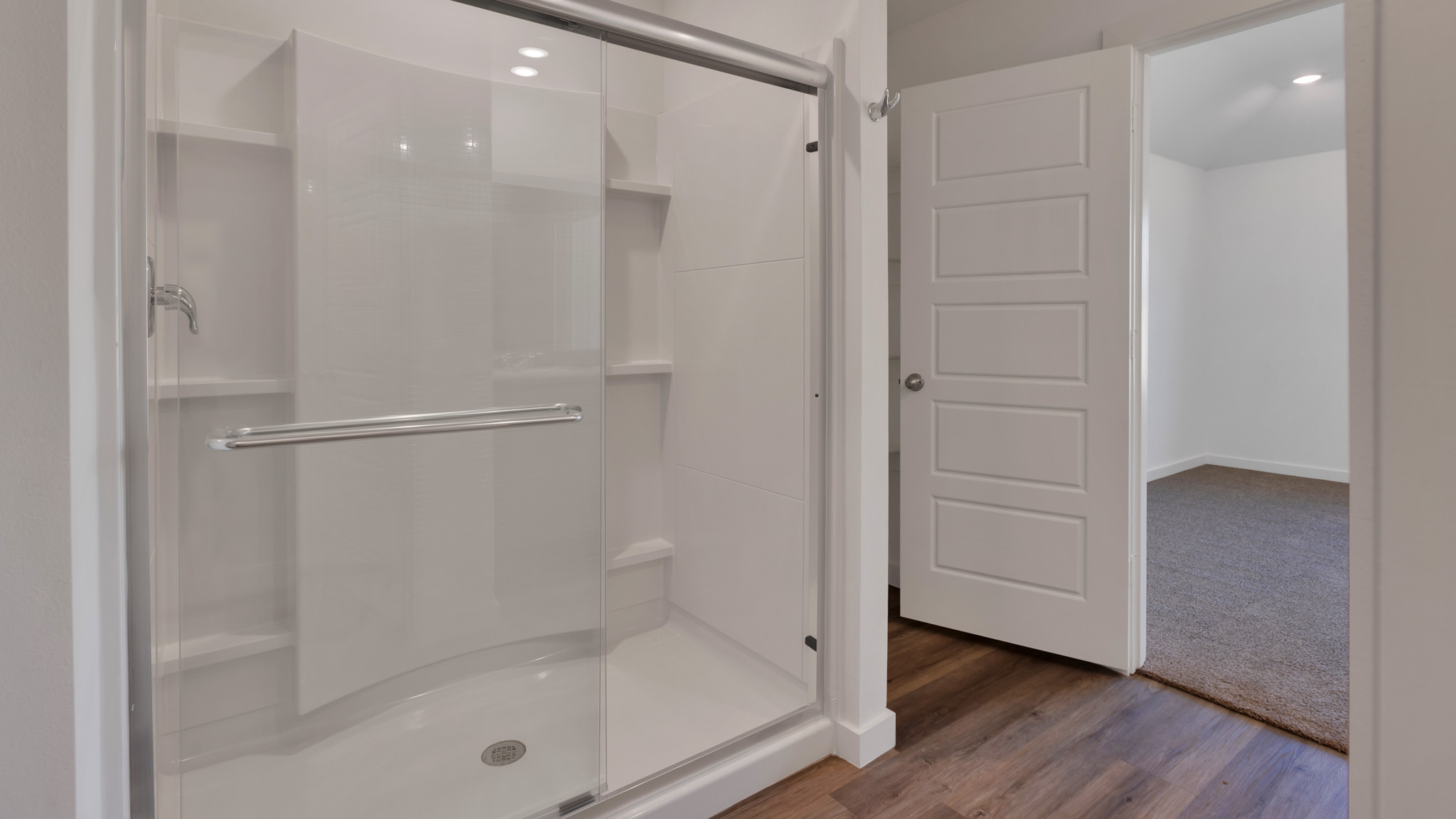 Primary bathroom with luxurious shower and built in storage