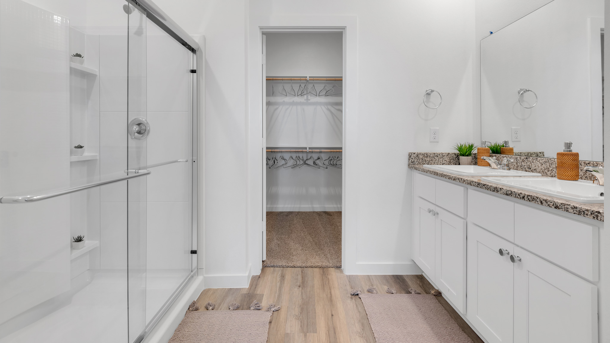 Primary bathroom with built in vanity and luxurious shower