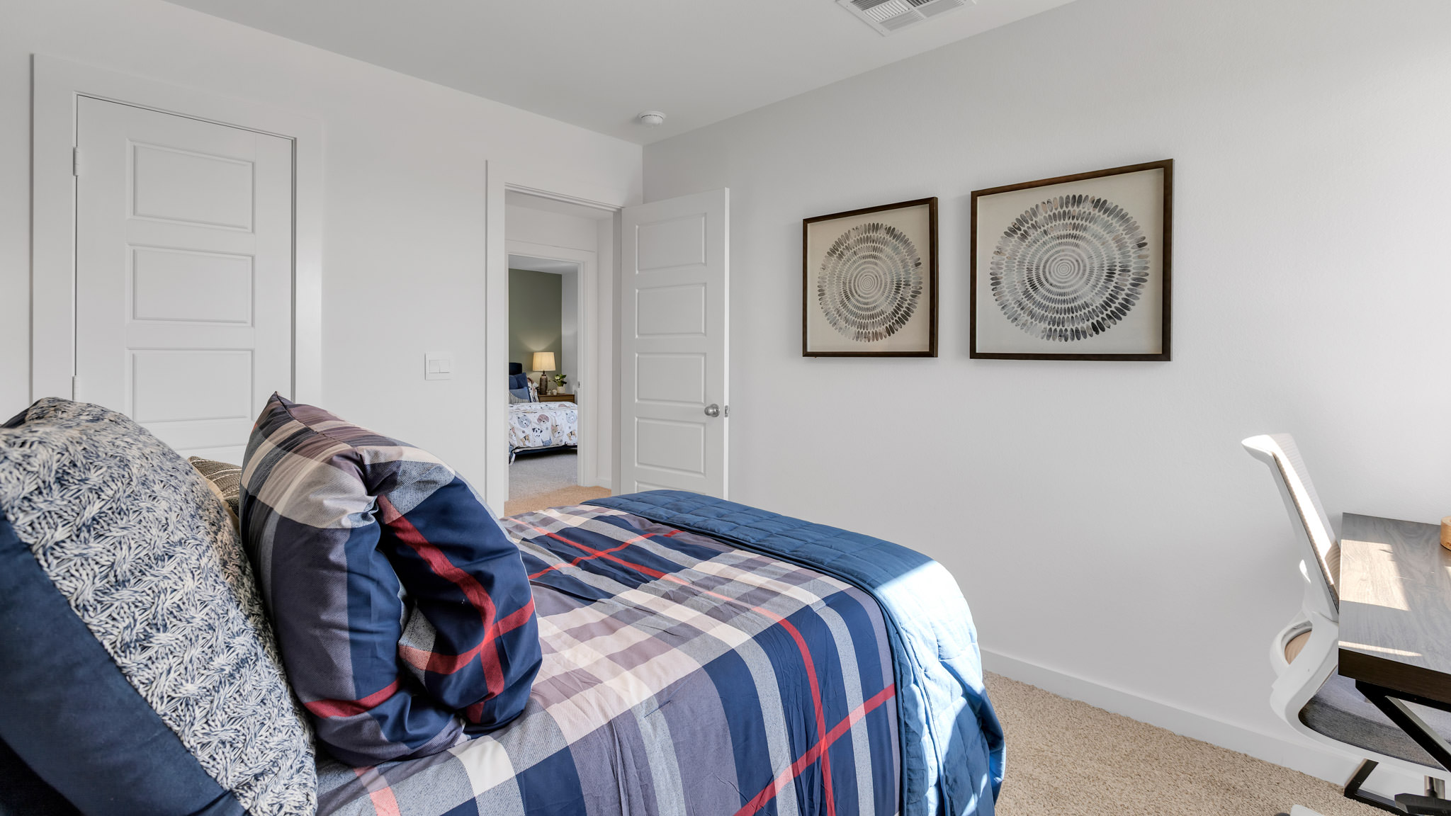 Guest bedroom with plush carpet floors and spacious closet