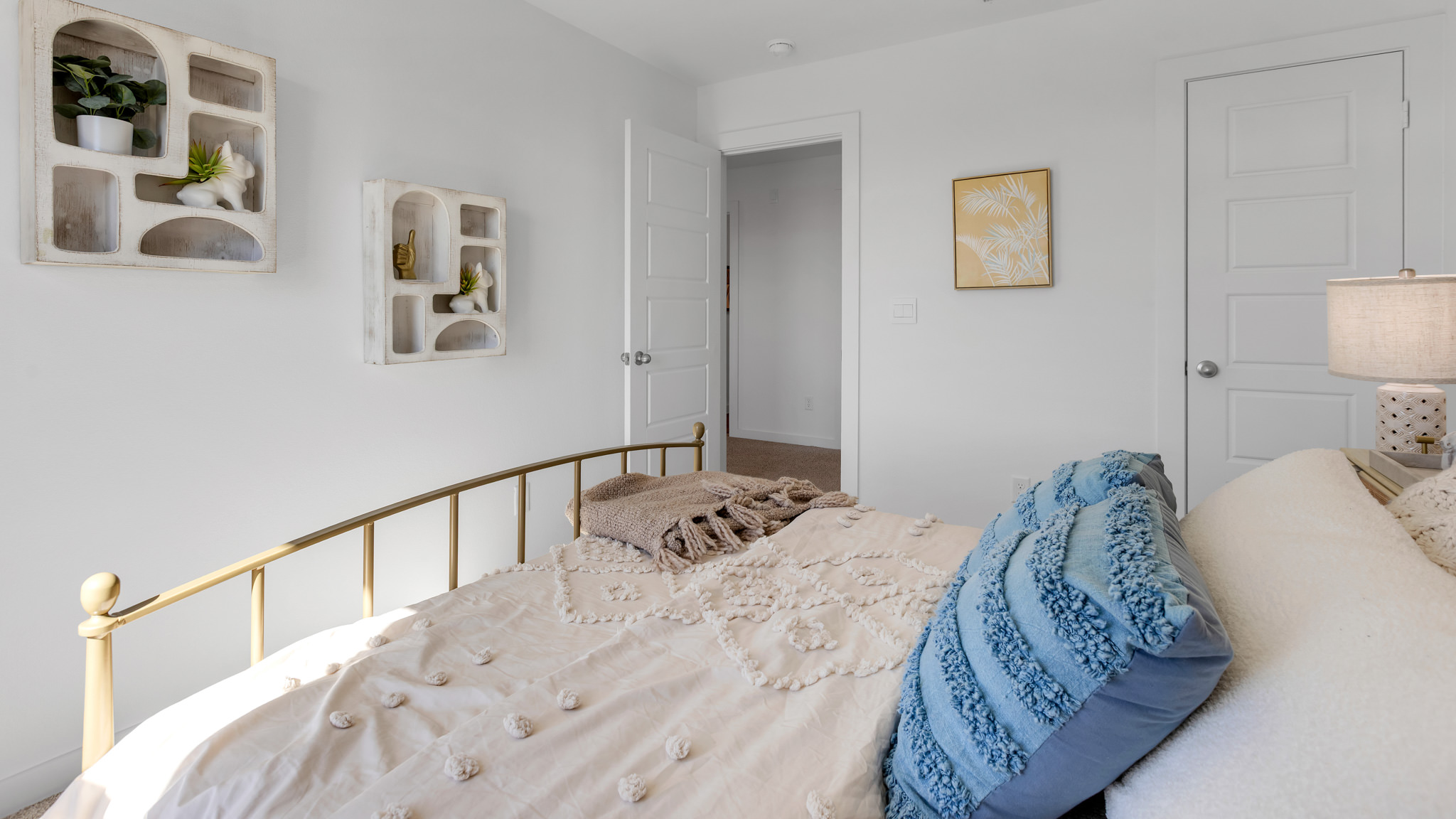 Guest bedroom with plush carpet floors and spacious closet