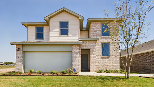 Single story home with brick, covered patio and two car garage