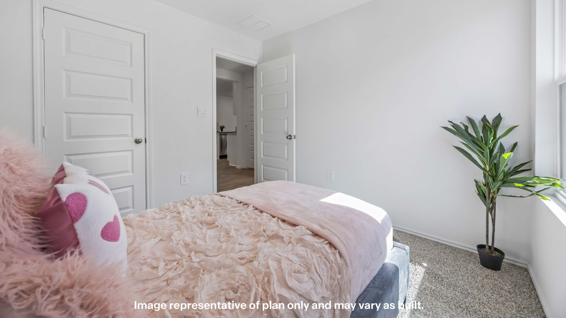 Guest bedroom with plush carpet floors and spacious closet