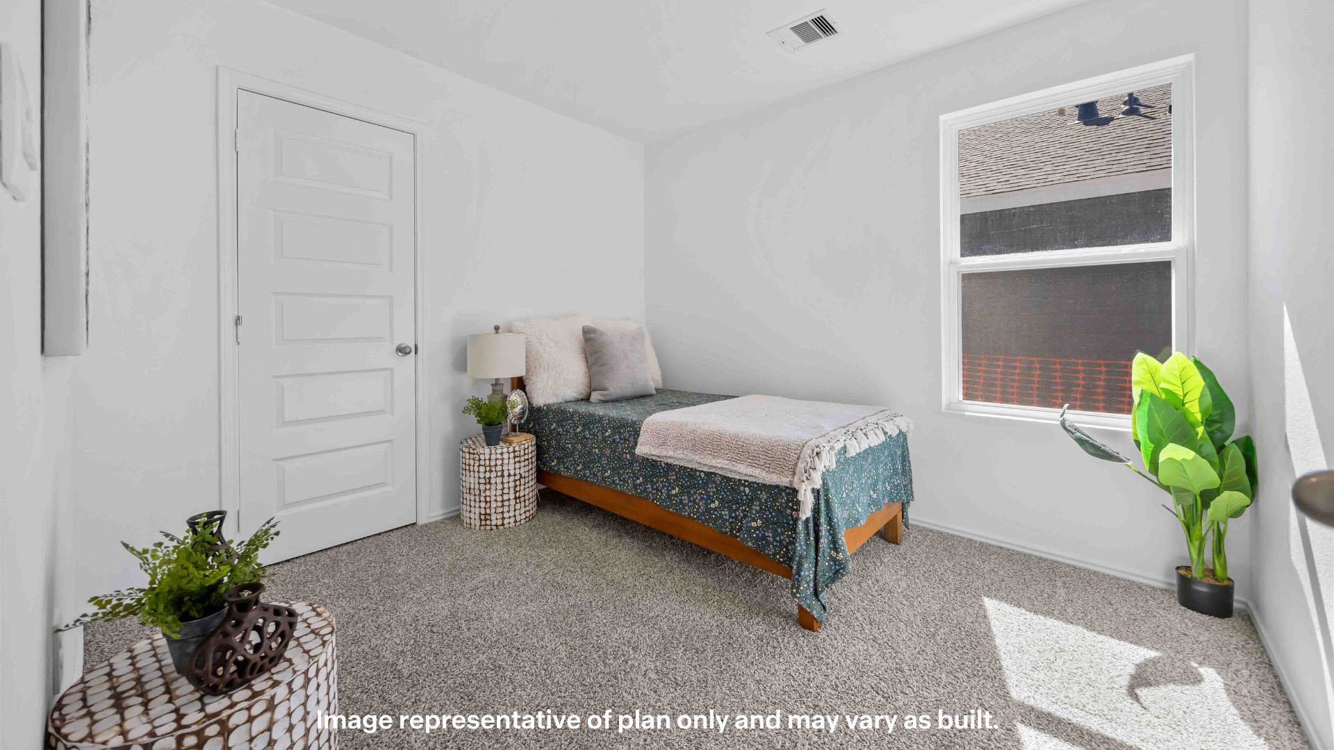 Guest bedroom with side window and plush carpet floor