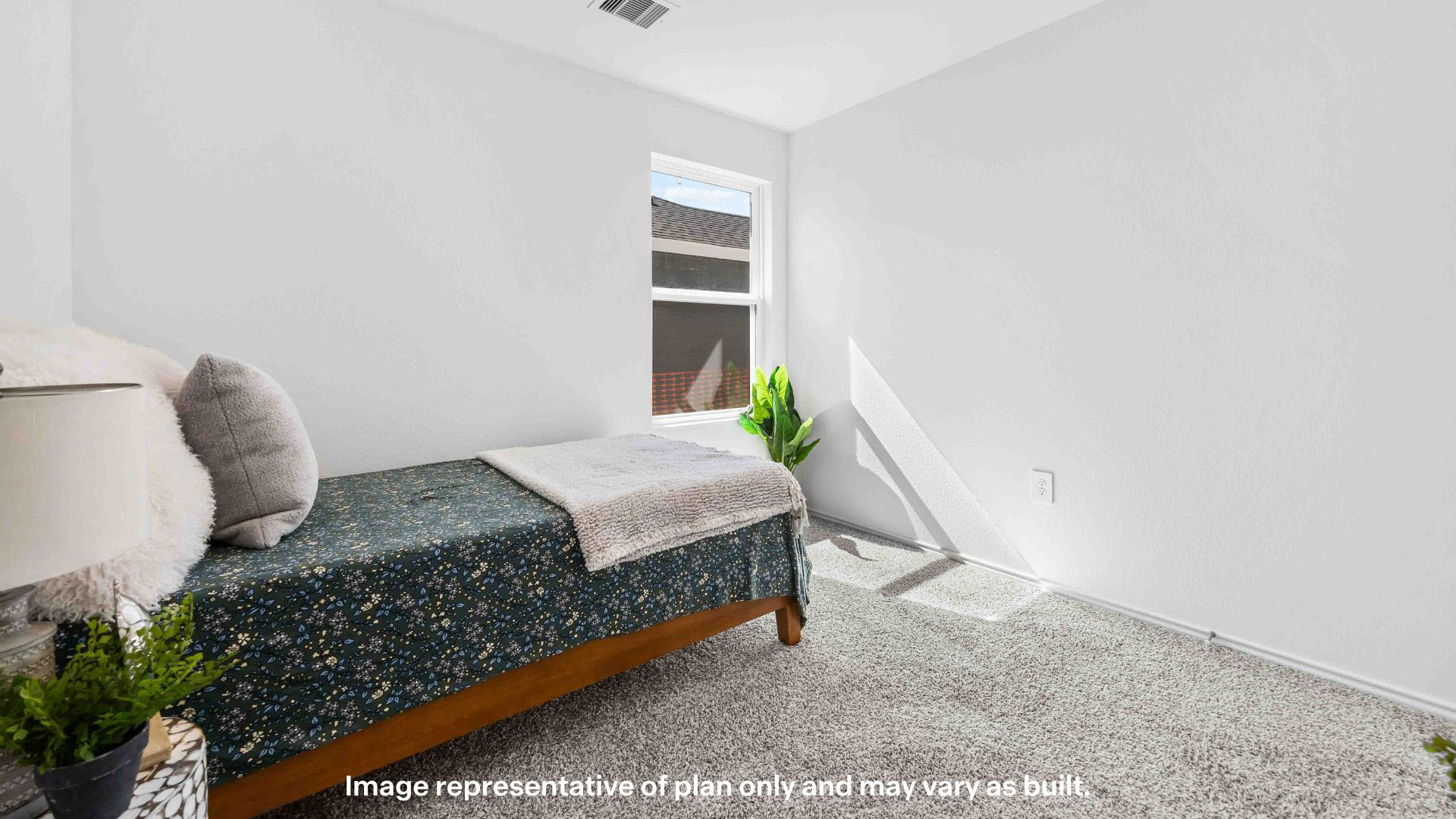 Guest bedroom 1 with plush carpet floors and spacious closet