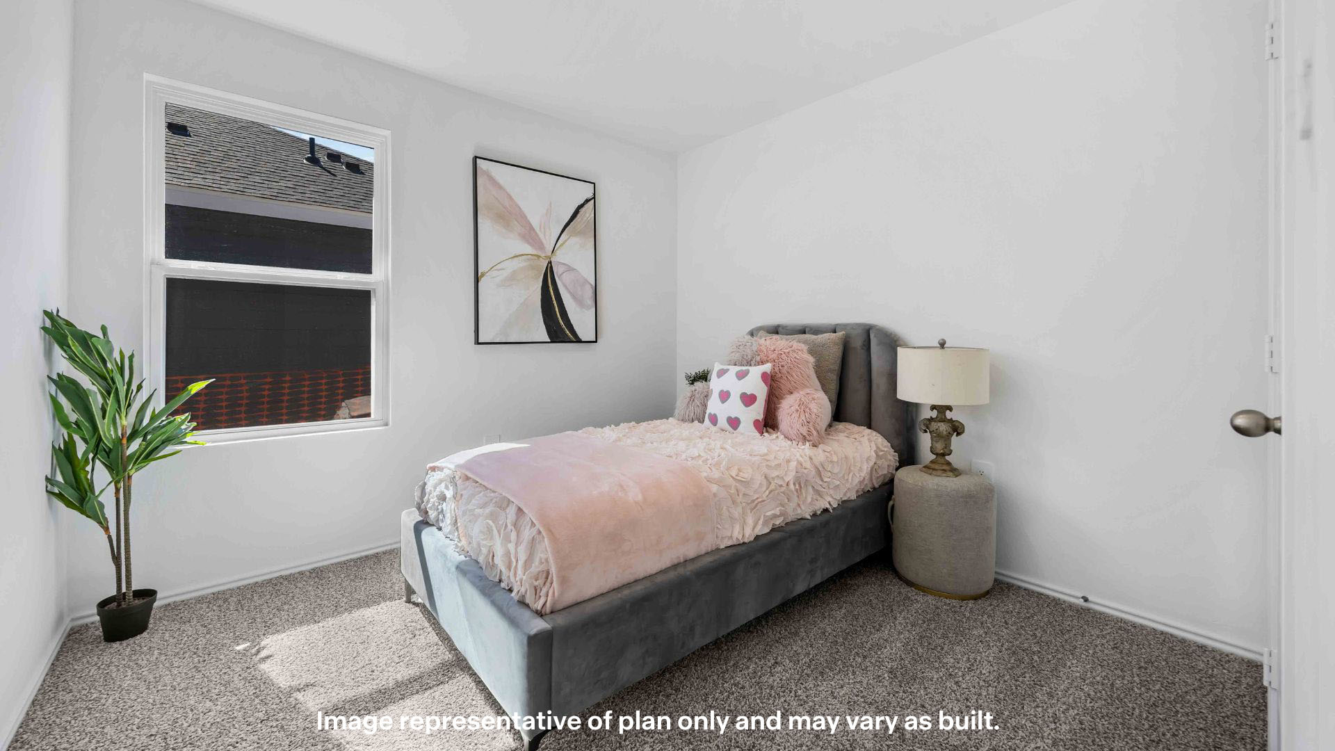 Guest bedroom with side window and plush carpet floor