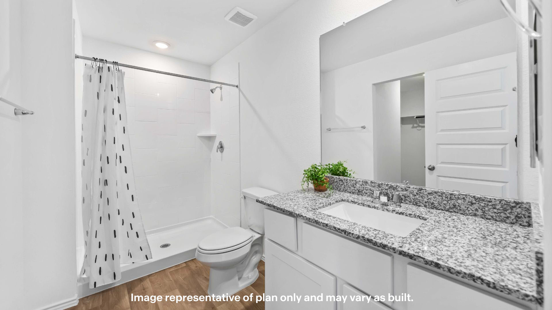 Private attached primary bathroom with built in vanity and luxurious shower