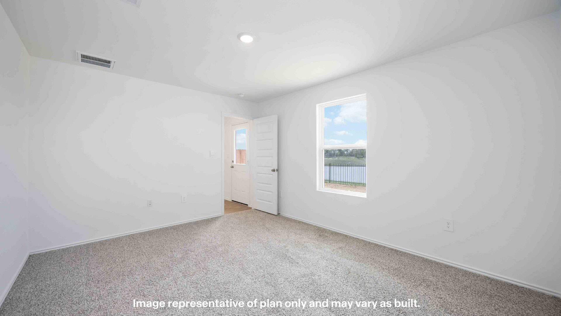 Primary bedroom with ample light and plush carpet floors