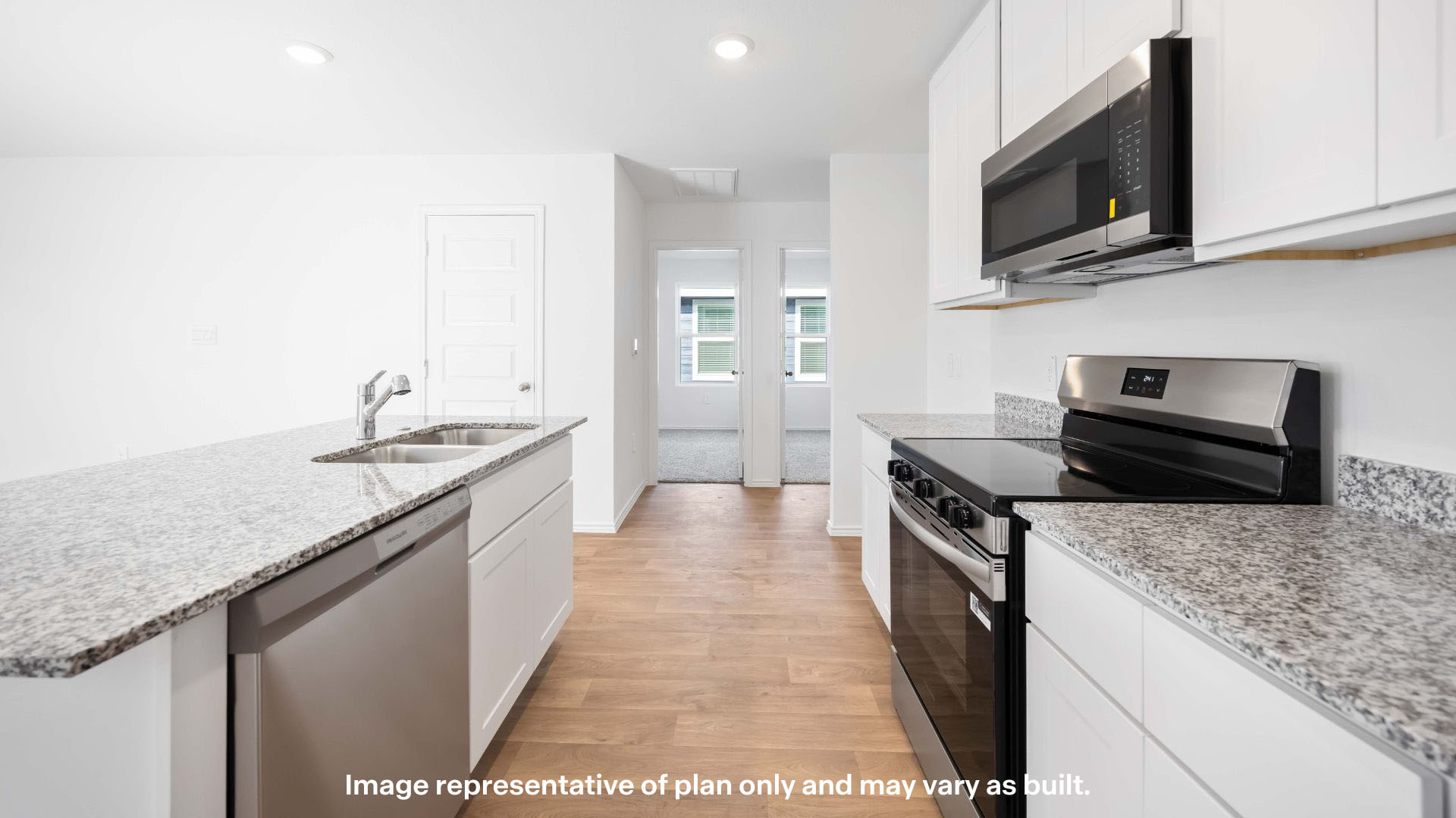 Open concept kitchen with stainless steel appliances, shaker style cabinets, and elevated finishes