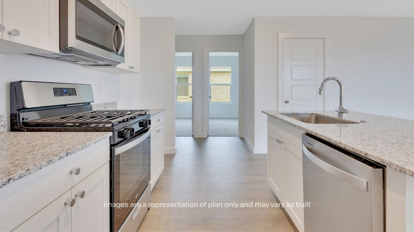 Open concept kitchen with stainless steel appliances, shaker style cabinets, and elevated finishes