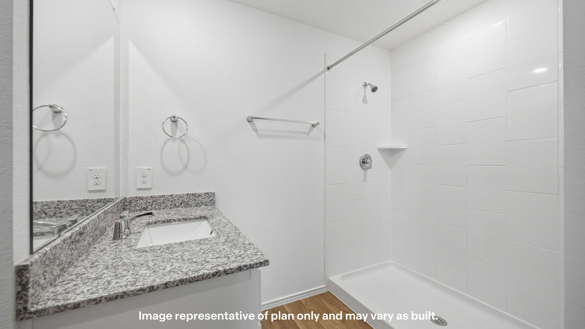 Private attached primary bathroom with built in vanity and luxurious shower