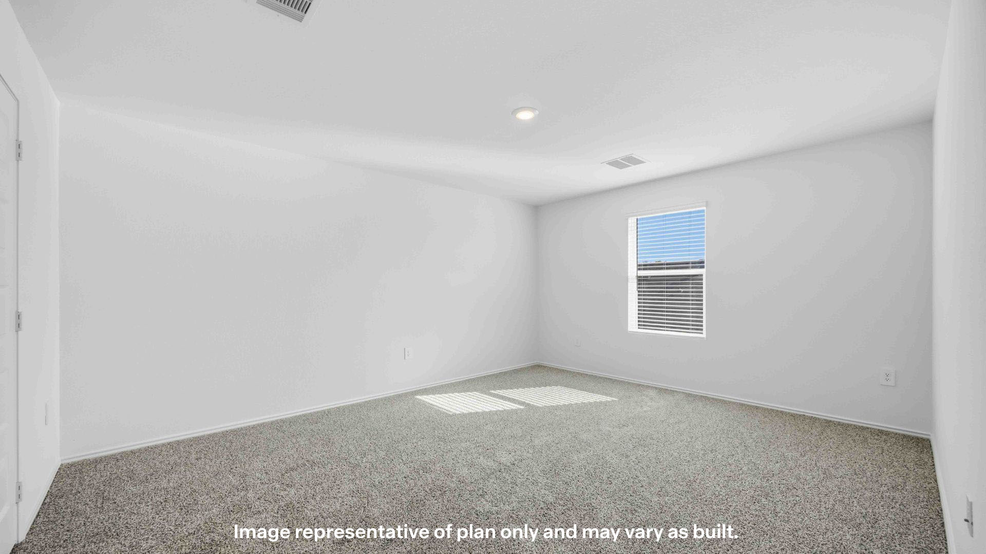 Primary bedroom with ample light and plush carpet floors