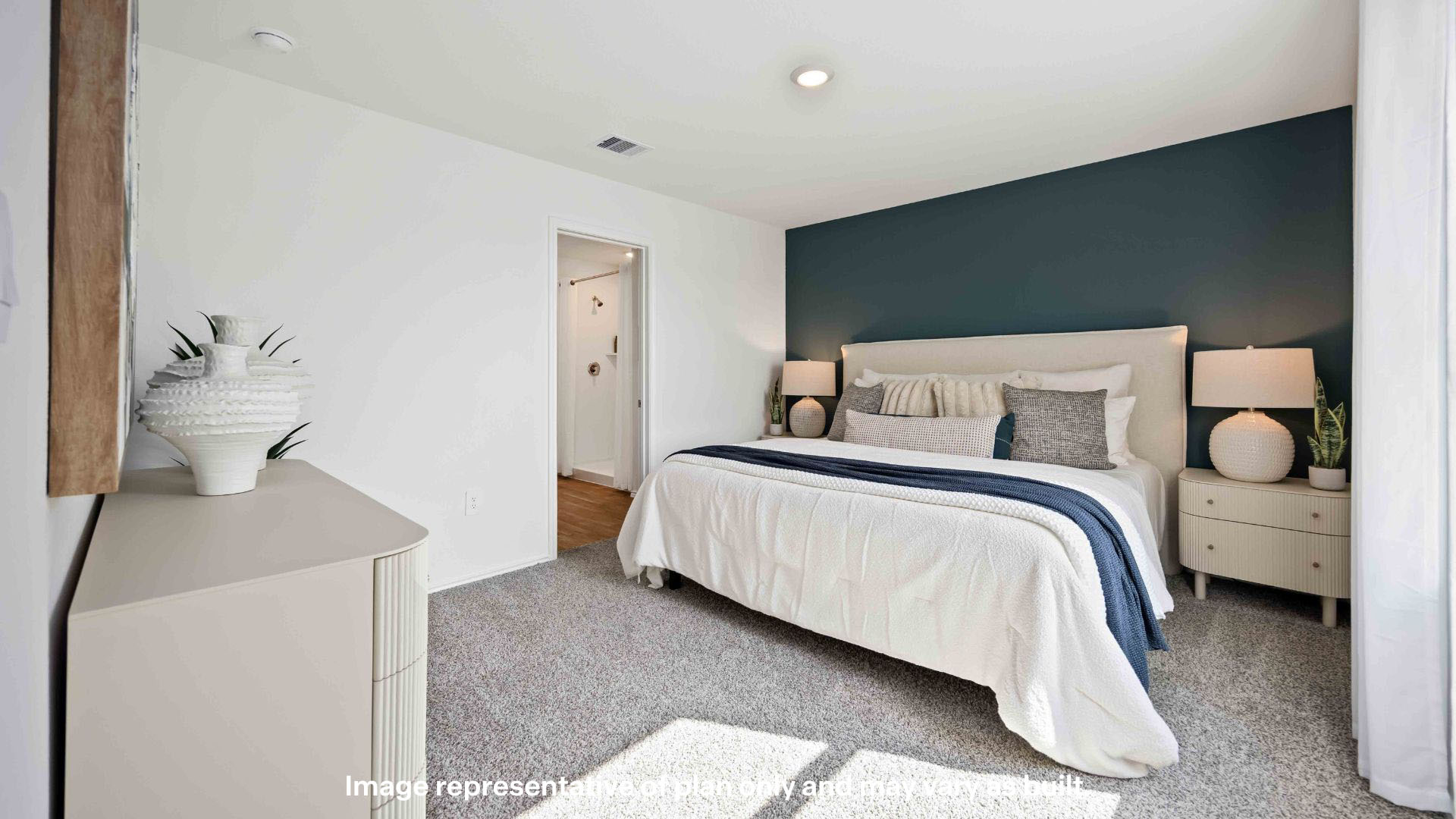 Primary bedroom with ample light and plush carpet floors