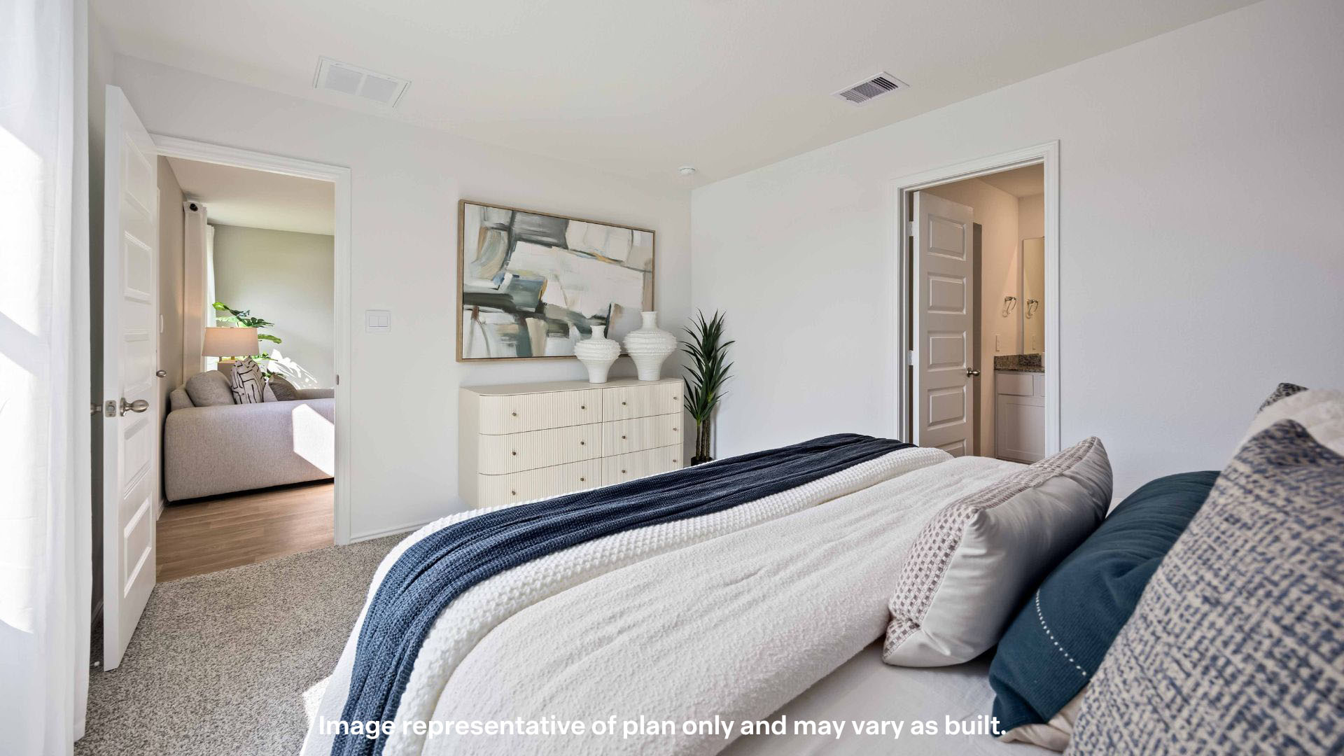 Primary bedroom with private attached bathroom and walk-in closet
